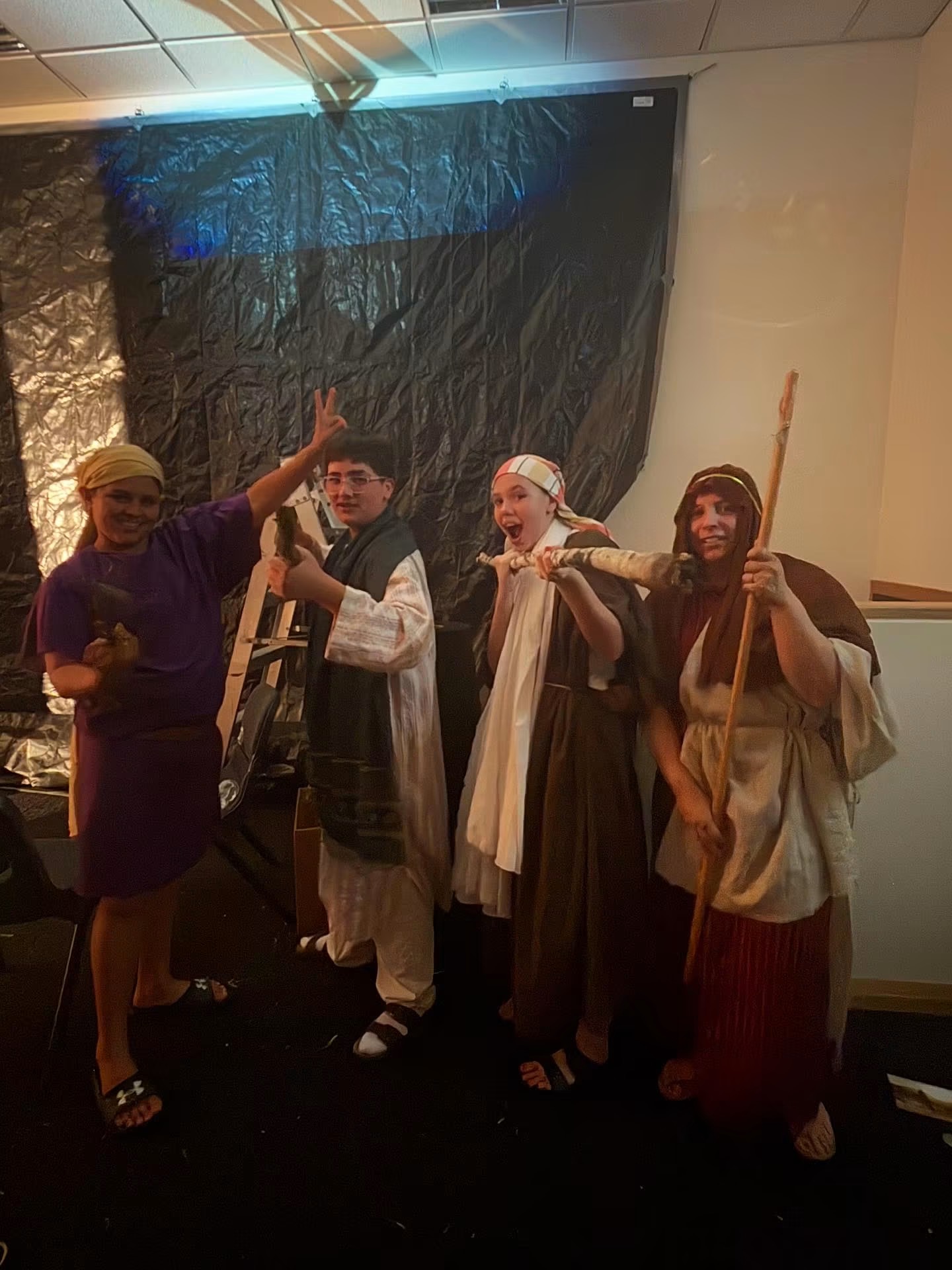 Cast members in costume as shepherds and villagers during the performance