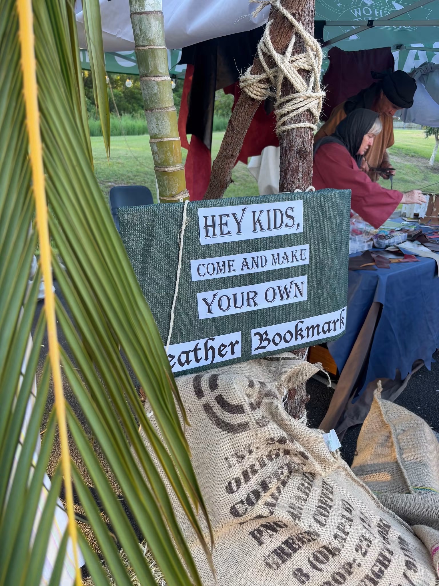 A hand-lettered sign inviting children to make their own leather bookmark